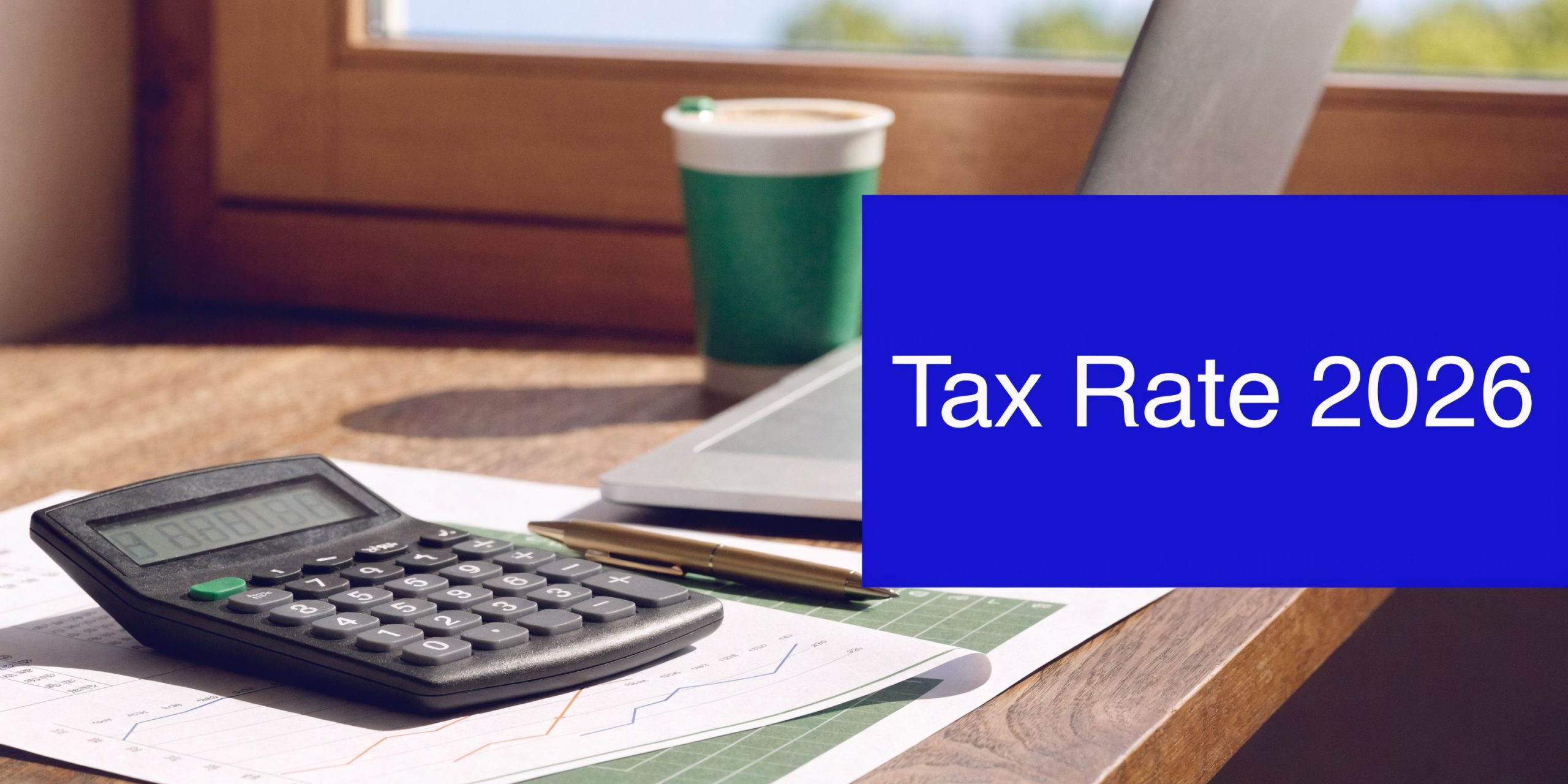 Calculator and financial documents on a desk with “Tax Rate 2026” text, representing company tax rates and financial planning
