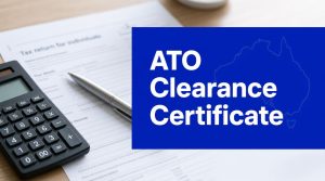 ATO clearance certificate concept showing tax return documents, calculator and Australian tax compliance paperwork for property settlement withholding rules.