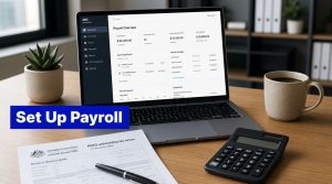 Laptop on a desk showing a payroll overview dashboard, with a PAYG tax form, calculator, coffee mug, and plant nearby, illustrating setting up payroll in Australia.