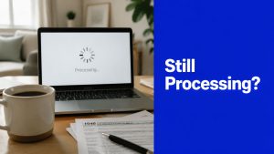 Laptop displaying a tax return processing screen with paperwork and a coffee mug on a desk, representing a myGov tax return still processing.