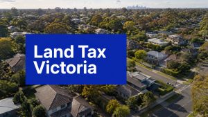 Aerial view of Melbourne homes with Land Tax Victoria text overlay