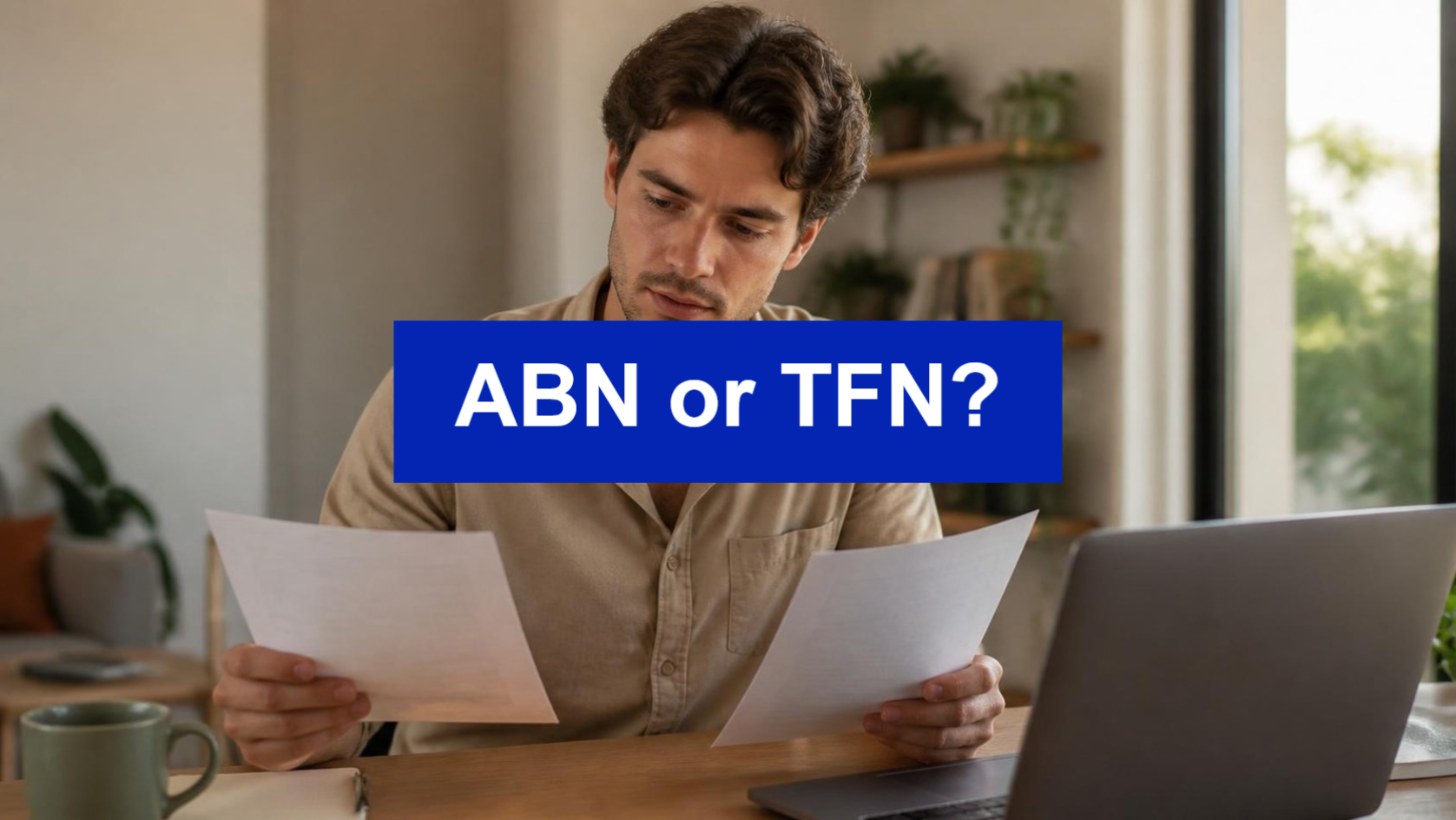 ABN or TFN - freelancer comparing tax forms at a home desk