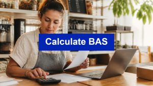 Calculate BAS - small business owner working through invoices with a calculator